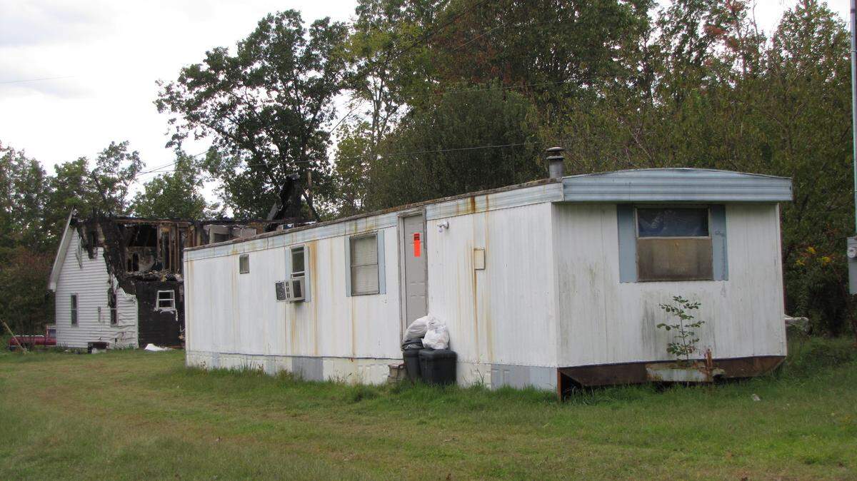A 2-year-old girl was checked for exposure to meth after two people were arrested Thursday on charges of making the drug at this trailer in Wayne County. The orange sticker on the door warns of meth contamination.