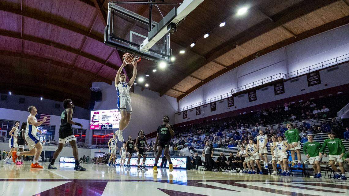 Lexington Catholic's Max Meagher (24) throws down a dunk during the Knights 42-41 win over the Defenders in the quarterfinals of the boys basketball 11th Region Tournament, Wednesday, March 4, 2026 at Eastern Kentucky University's Baptist Health Arena in Richmond, Ky.