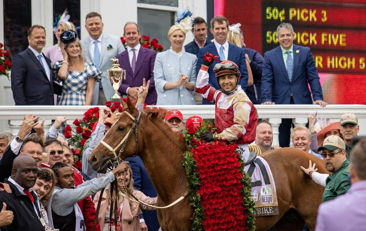 Jockey Sonny Leon and Rich Strike pause for a photo with friends, family and supporters after winning the 148th running of the Kentucky Derby at Churchill Downs on Saturday.