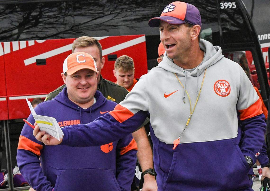 Clemson head coach Dabo Swinney and defensive coordinator Wes Goodwin arrive for practice Wednesday at Fernandina Beach High School in Jacksonville, Florida. The Tigers face Kentucky in the Gator Bowl on Friday.