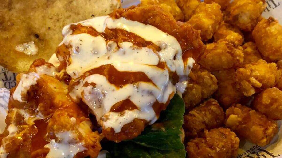 The Spicy Mother Clucker Chicken Sandwich and tots at Tilted Kilt, which has opened next to KSBar and Grille just off South Broadway.