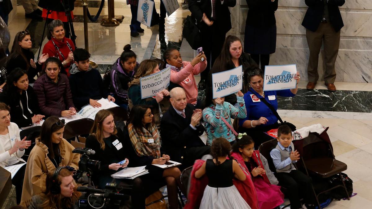 Participants held signs during a rally organized by The Coalition for a Smoke-Free Tomorrow, held Tuesday morning in the rotunda of the State Capitol in Frankfort, to launch a campaign urging legislators to pass HB11 and SB27, which would prohibit use of any tobacco product by all persons at all times on or in school. At top is Senator Ralph Alvarado, R-Winchester, Representative Kimberly Moser, R-Taylor Mill, and Robb Smith-Superintendent Bellevue Independent Schools.