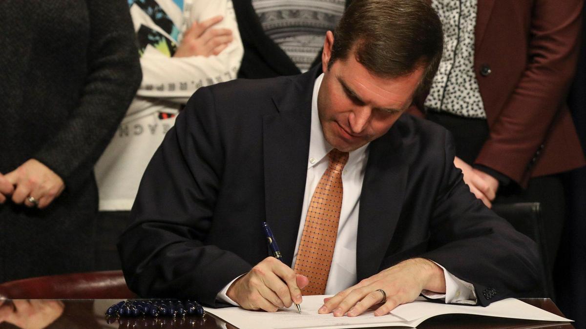 Kentucky Gov. Andy Beshear signs an executive order rescinding the state’s Medicaid work requirements proposed by former Gov. Matt Bevin during a press conference at the Capitol in Frankfort, Ky., Monday, Dec. 16, 2019.