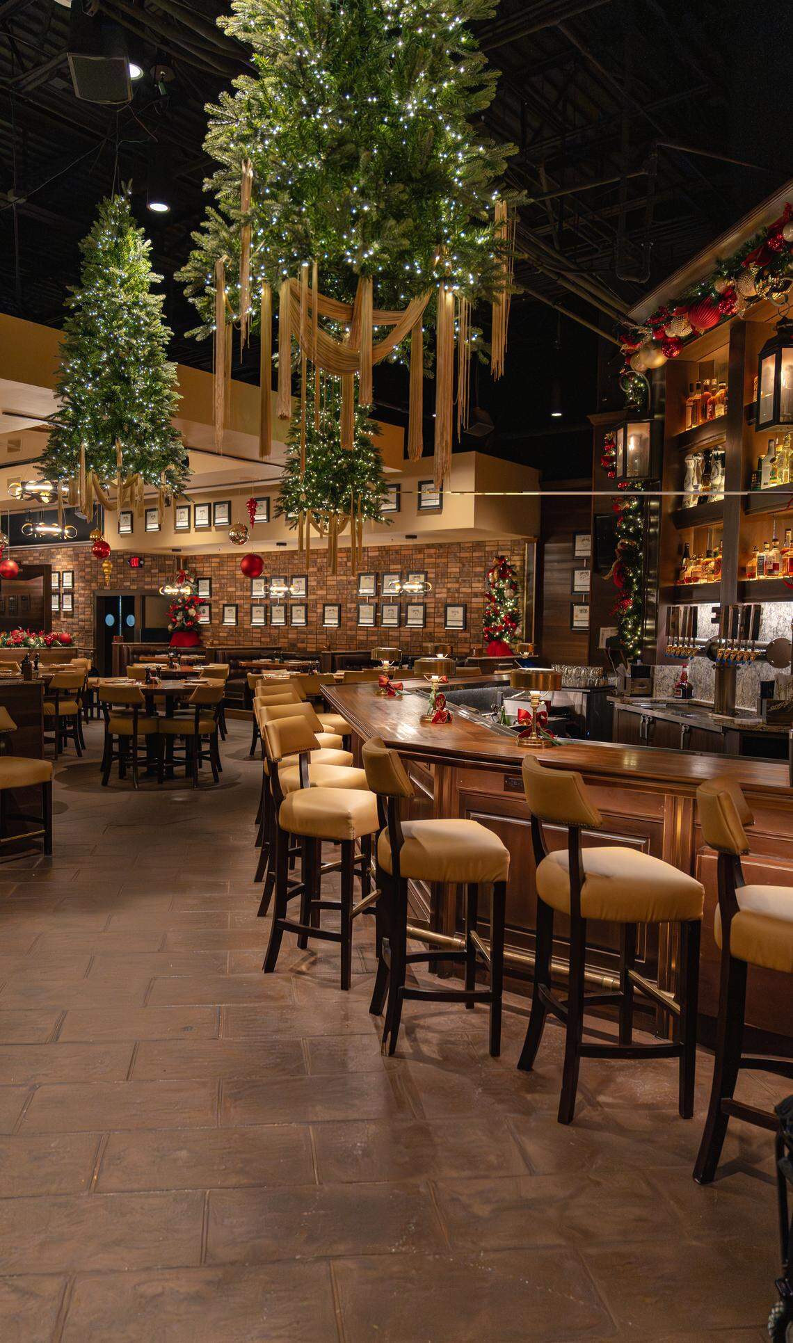 Festive Christmas trees hang from the ceiling at Malone’s in Palomar.