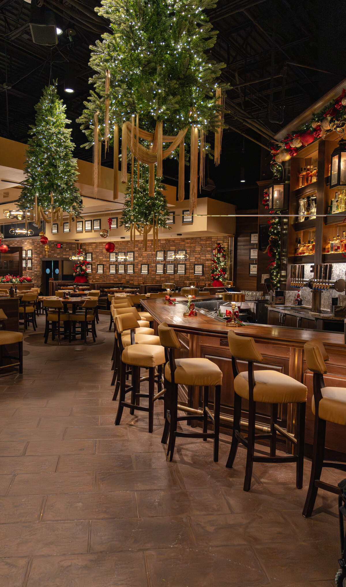 Festive Christmas trees hang from the ceiling at Malone’s in Palomar.