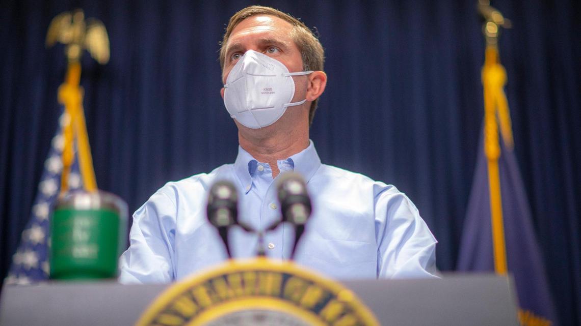 Kentucky Gov. Andy Beshear arrives at a media conference at the Kentucky state Capitol in Frankfort, Ky., on Monday, Nov. 22, 2021.