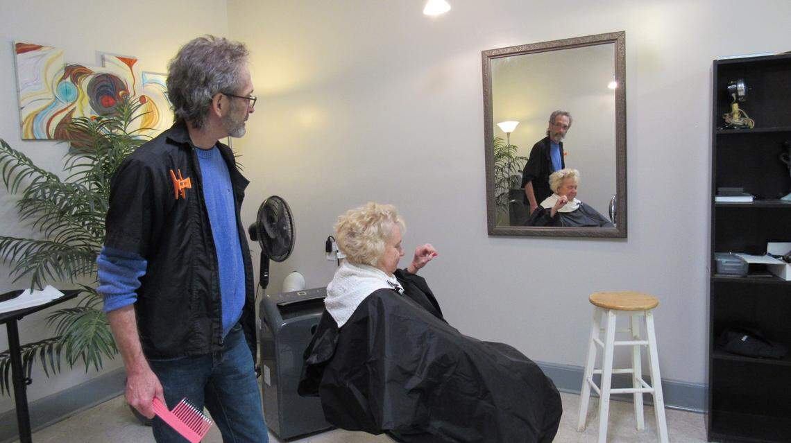 Johnny Cummings, who served two terms as mayor of Vicco, in Perry County, with customer Kay Crowe at his shop in the small town on Nov. 18, 2022