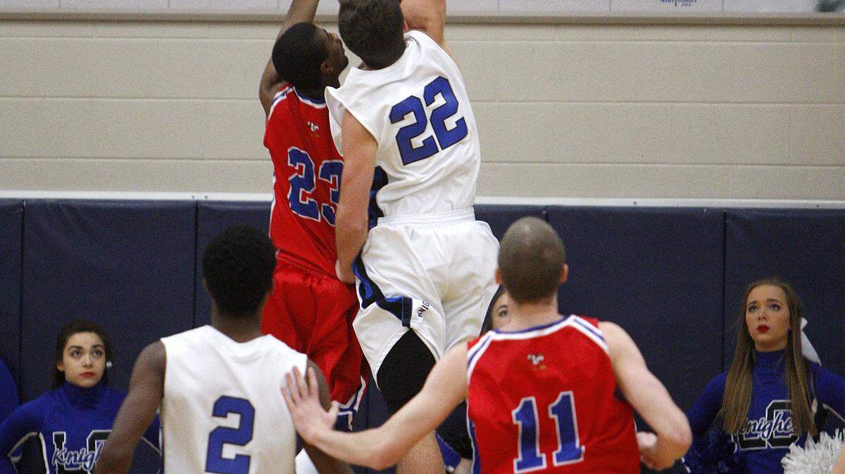 Lexington Catholic's Reese Ryan (22) blocked the shot of Scott County's Isaiah Johnson. Ryan had 16 points, 10 rebounds and five assists. "I don't think there's anything quite like beating Scott County," he said.            