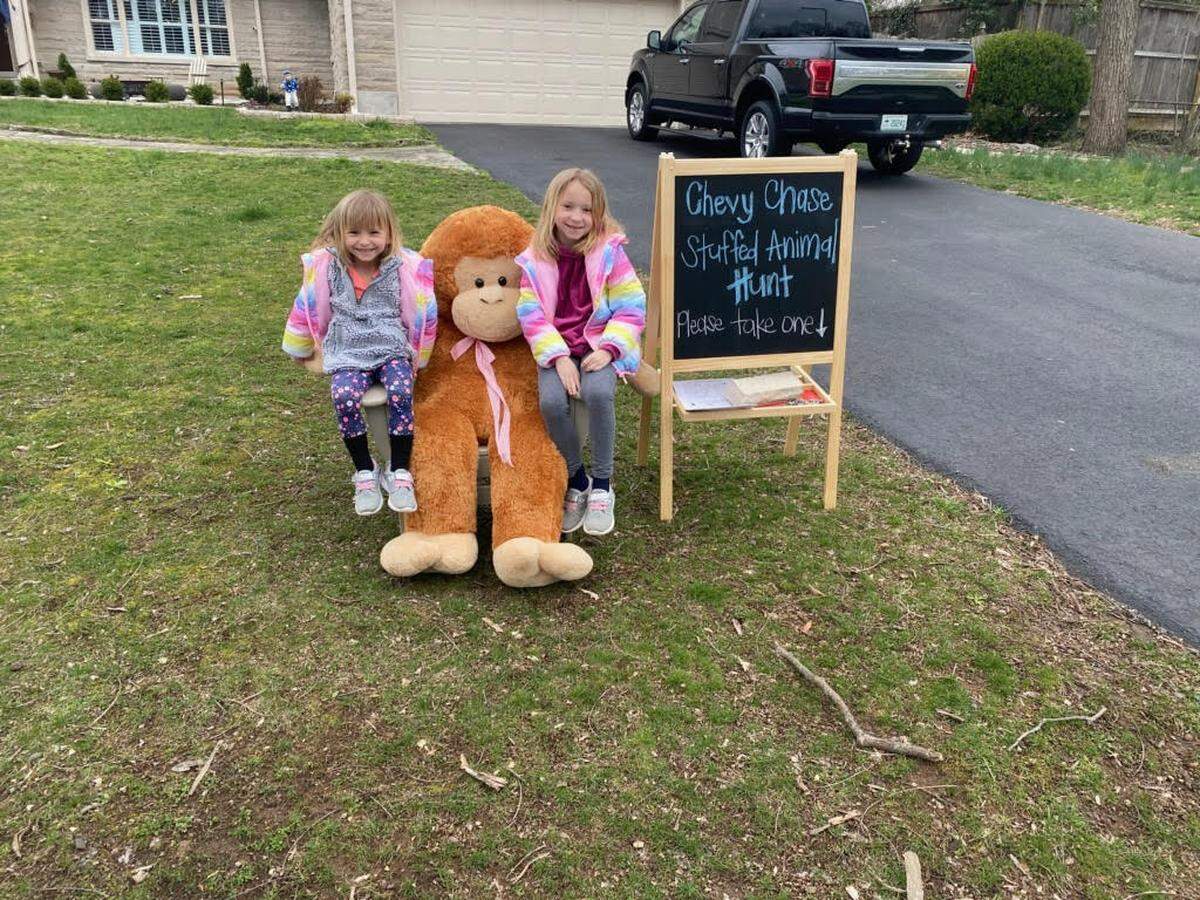 Andrew Dieruf’s daughters posed in front of a stuffed animal for the family’s stuffed animal hunt, an activity that has gotten the attention of much of their neighborhood.