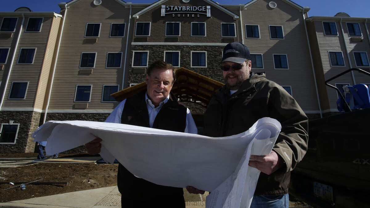 Developer Dennis Anderson, left, and engineer Mike Craft looked over plans in the 50-acre-plus Townley Center development on Leestown Road last week.