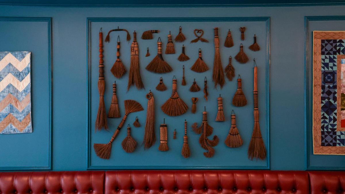 A collection of broom craft on the wall of Crafted at Boone Tavern, Monday, July 14, 2025 at Crafted at Boone Tavern, the new restaurant at the Historic Boone Tavern Hotel in Berea, Ky. The dining room seats 54 and is decorated with weavings, broom, wood and more crafts by Berea College Student Craft.