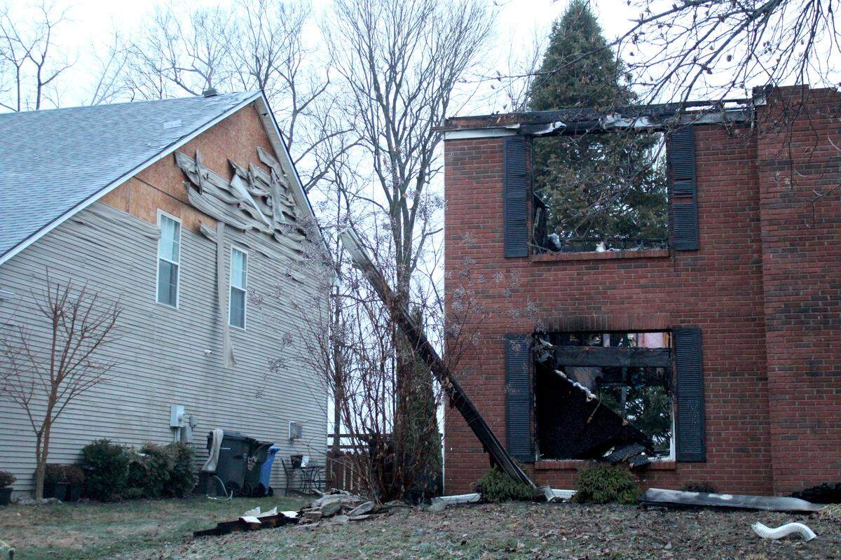A neighboring home next to a house that caught on fire Meadow Valley Road Jan. 1, 2026, suffered siding damage.