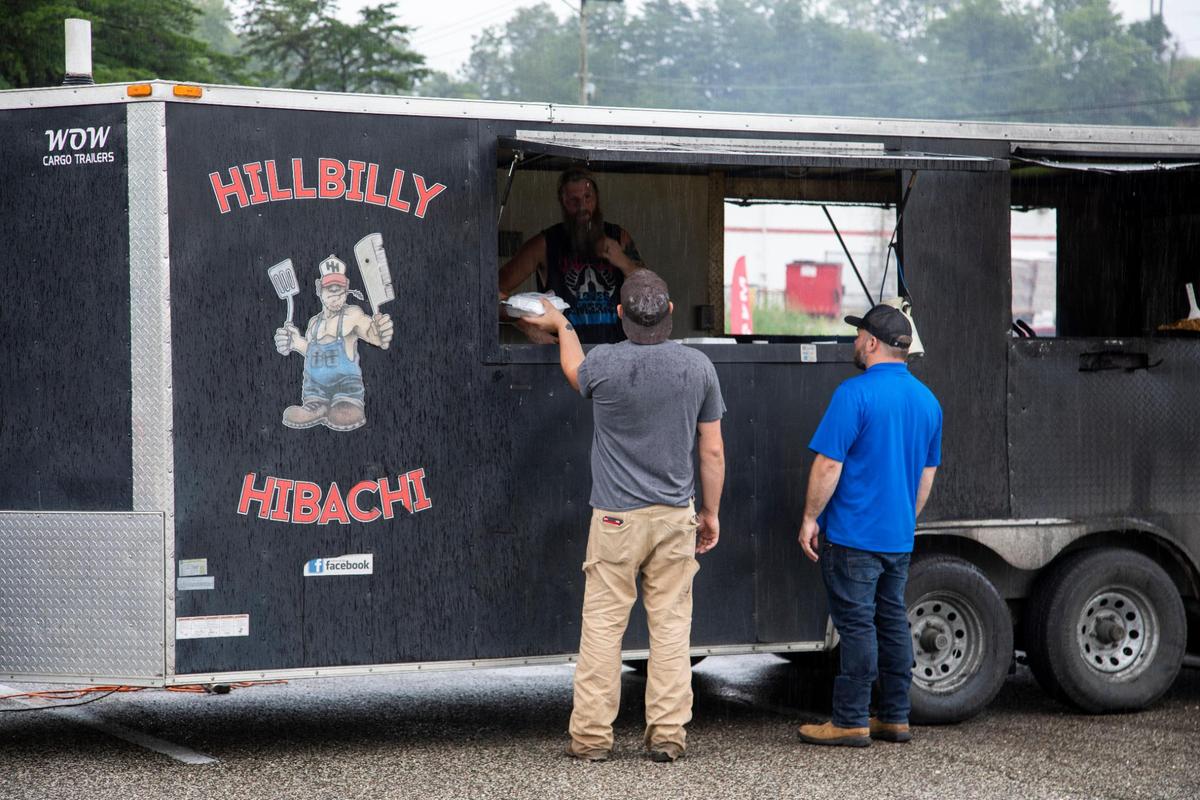 Co-owner Adam Brown cooks in the Hillbilly Hibachi food truck in Ashland. Fans follow them online to find the truck daily.