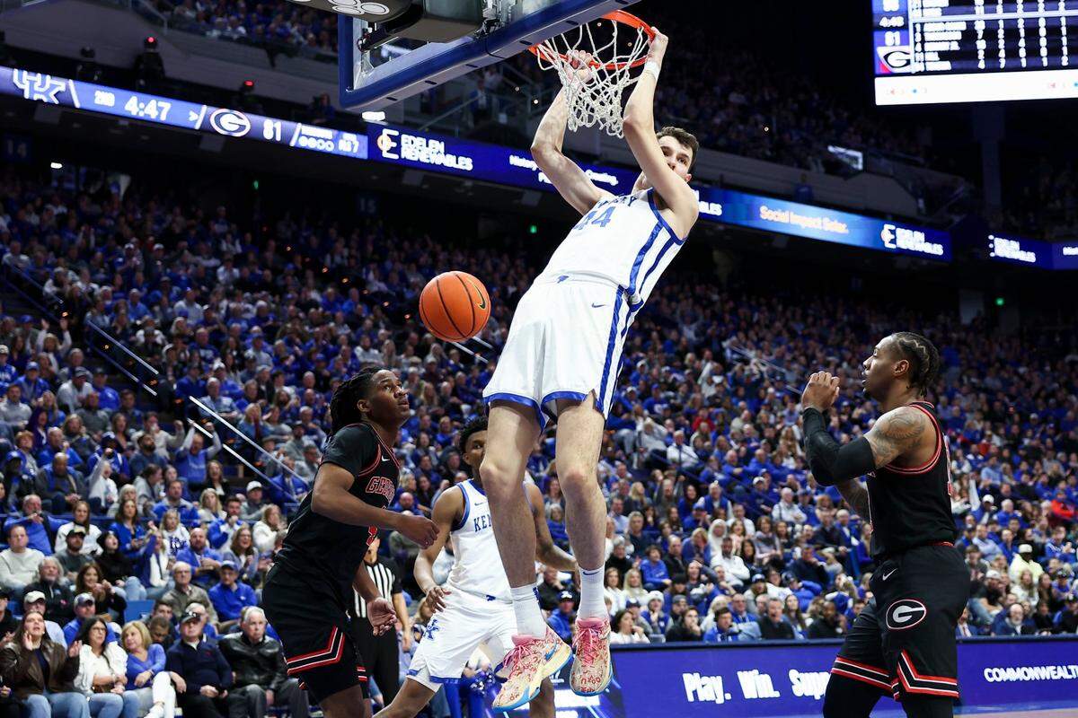 Kentucky forward Zvonimir Ivisic (44) hangs on the rim (he was called for a technical foul) after a dunk against Georgia. Ivisic was 5-for-7 from the field, including 3-for-4 from 3-point range.