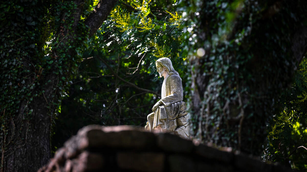 A statue of Jesus Christ delivering the Sermon on the Mount at the Garden of Hope in Covington, Ky., overlooks the Cincinnati skyline across the Ohio River.