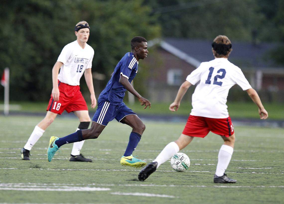 Bryan Station’s Diallo Irakoze dribbles through two Lafayette defenders during a high school game in 2018. Irakoze is back in Lexington and will be part of the first-ever USL League One roster for Lexington Sporting Club.