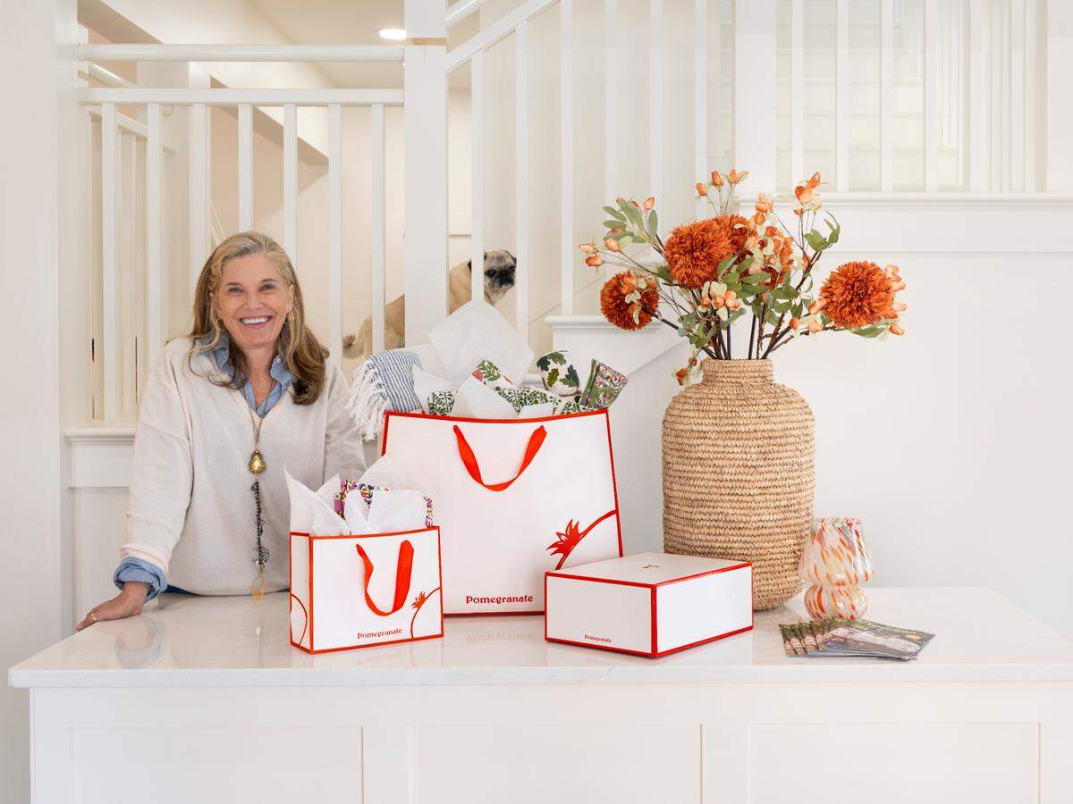 Pomegranate founder and creative director Angela Beck, with her pug Penelope, in the new store opening at 700 E. Main St. in Lexington on Dec. 3. Pomegranate also will have a cafe, Penny’s at Pomegranate, serving a menu created by chef Ouita Michel and wines from Beck’s Oregon vineyard.