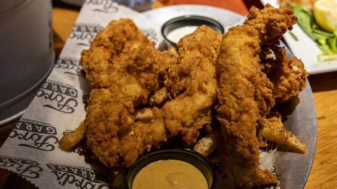 Hand-Battered Chicken Tenders ($15.99) at Ford’s Garage, photographed Tuesday, Nov. 4, 2025 in Lexington, Ky., are served with their signature honey mustard and Hidden Valley Ranch and choice of one side.