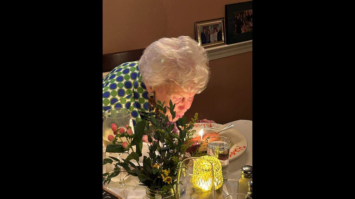 Isabel Yates blows out candles on the cake for her 100th birthday. (Glenn Yates)