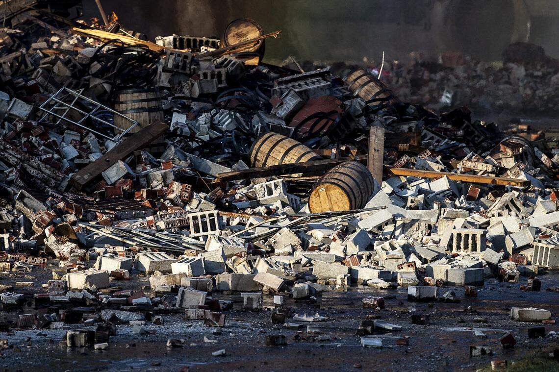 A fire at a Jim Beam warehouse in Woodford County left piles of rubble and barrels of bourbon.