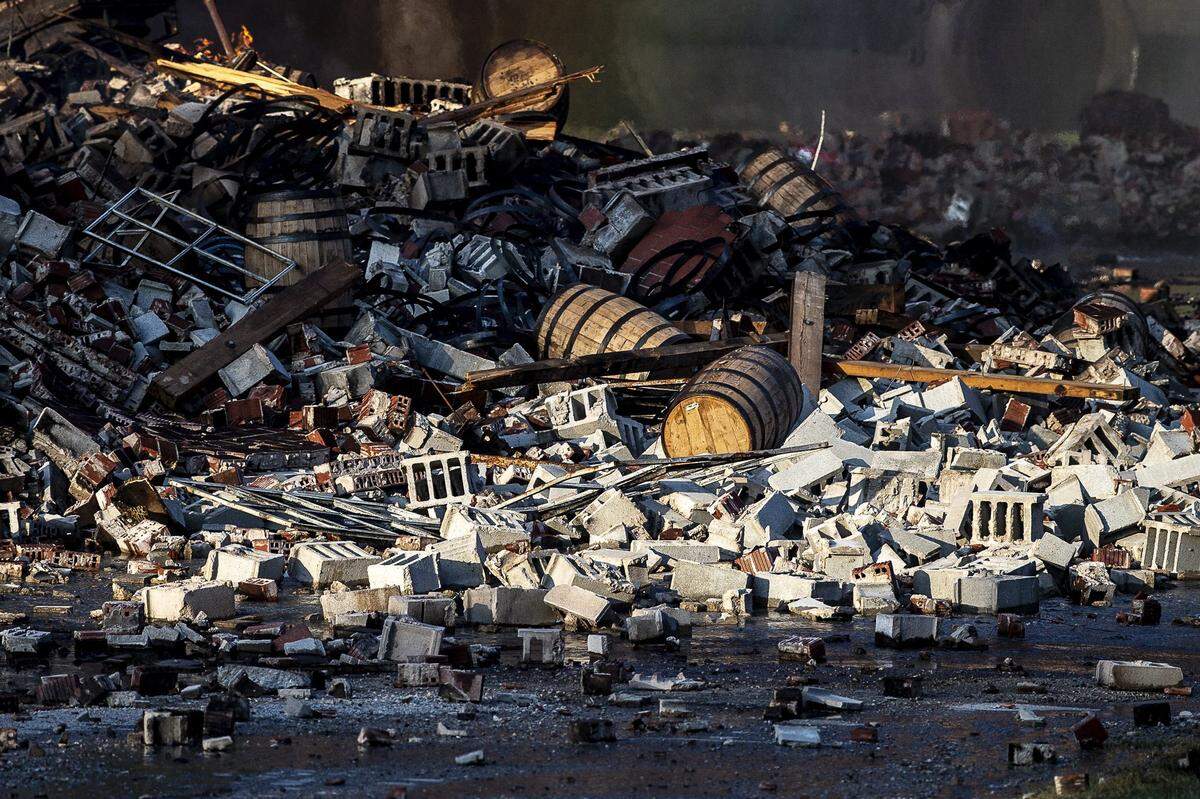 A fire at a Jim Beam warehouse in Woodford County left piles of rubble and barrels of bourbon.