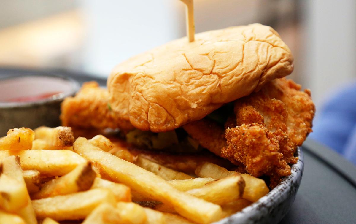 The fried catfish sandwich with a side of french fries at Infinity: Skybar & Cafe.