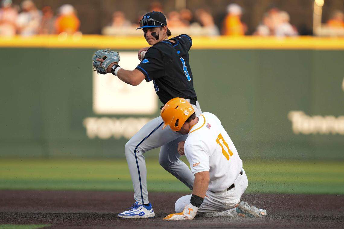 Kentucky infielder Tyler Bell (6) throws the ball to first base after getting Tennessee infielder Andrew Fischer (11) out at second base during a NCAA baseball game between Tennessee and Kentucky at Lindsey Nelson Stadium in Knoxville, Tenn., on April 18, 2025.