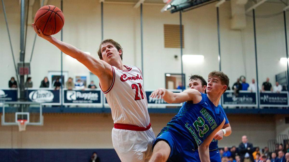 Clark County’s Tanner Walton (21) reached for a rebound during a 77-64 win against North Laurel at Lexington Catholic on Dec. 28, 2021.