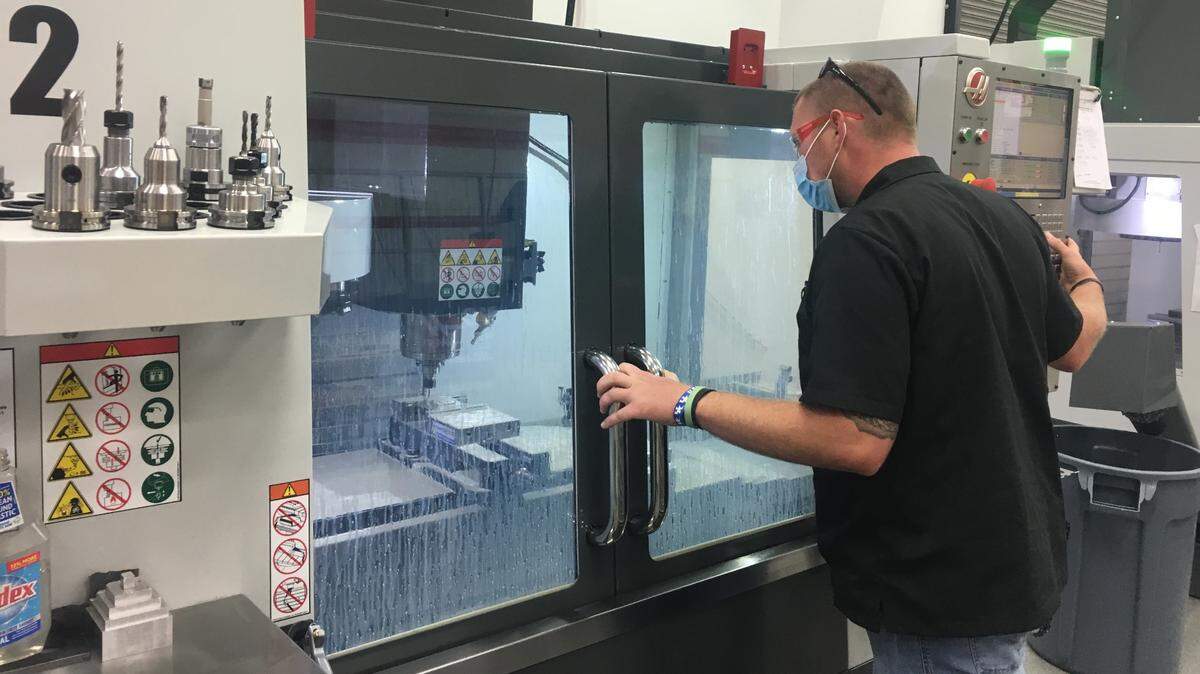 Earl Fitch, of Paintsville, makes a University of Kentucky paperweight with a CNC machine, which are used to cut into hard materials, at eKAMI on Wednesday afternoon. Fitch worked in the coal mines from 2006 to 2018 before becoming a student at eKAMI where he now works.