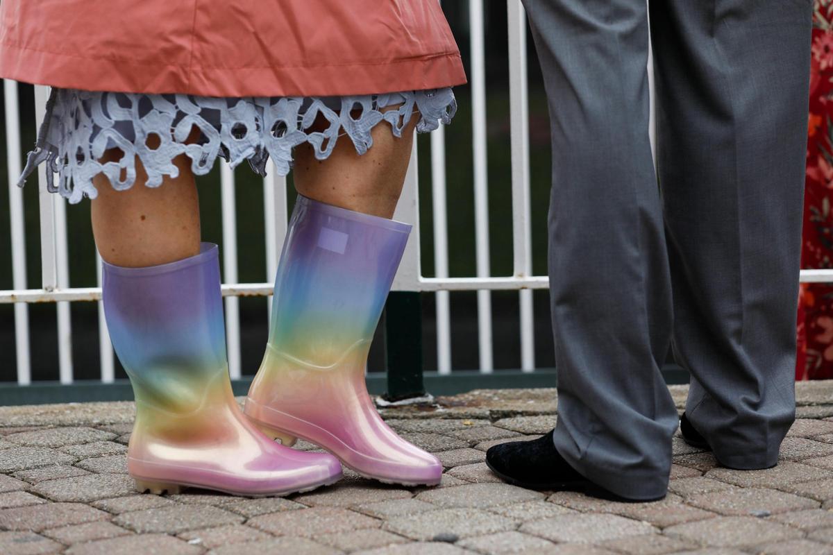 Jennifer Ball, from Louisville, made a last minute purchase of rain boots at Target to wear at Churchill Downs in Louisville, Ky., Saturday, May 7, 2022. “I’m going to be comfy, I’m going to be happy and enjoy this derby to the finest,” she said.