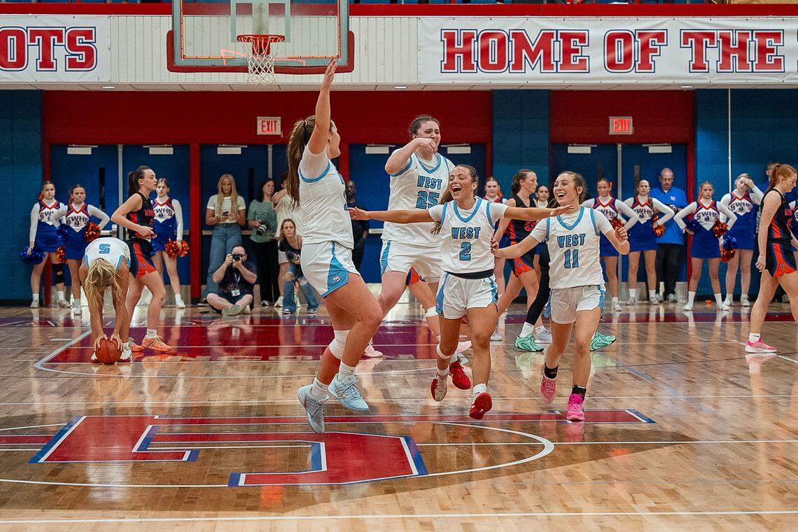 As West Jessamine’s Isabella Lewis (5) dropped the ball to the court her teammate (from left) Claire Marshall, Kimberly Johnson, Ariana McLoney and Katie Mastin celebrated the Colts’ 48-39 win over Southwestern as the final horn sounded in the girls 12th Region Tournament championship game at Lincoln County High School in Stanford on Saturday.