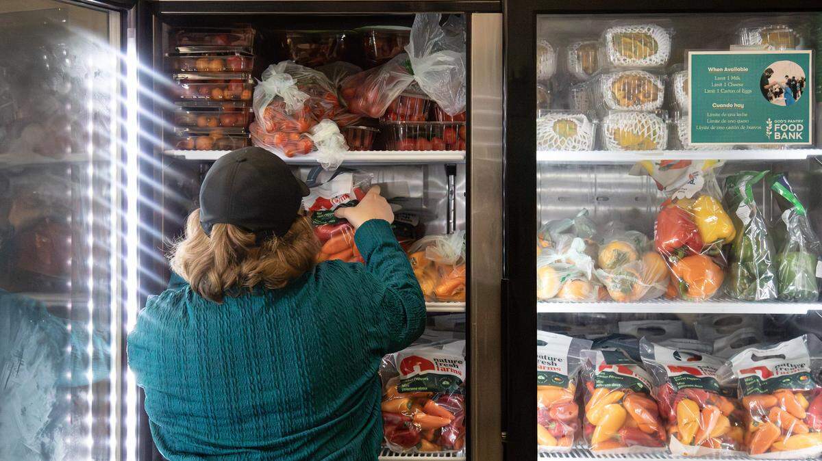Local volunteer Tiffany Rice ensures frozen foods are neatly arranged and easily accessible in a freezer at God's Pantry Food Bank Volunteer Center on Nov. 3, 2025, at 817 Winchester Road in Lexington, Ky.