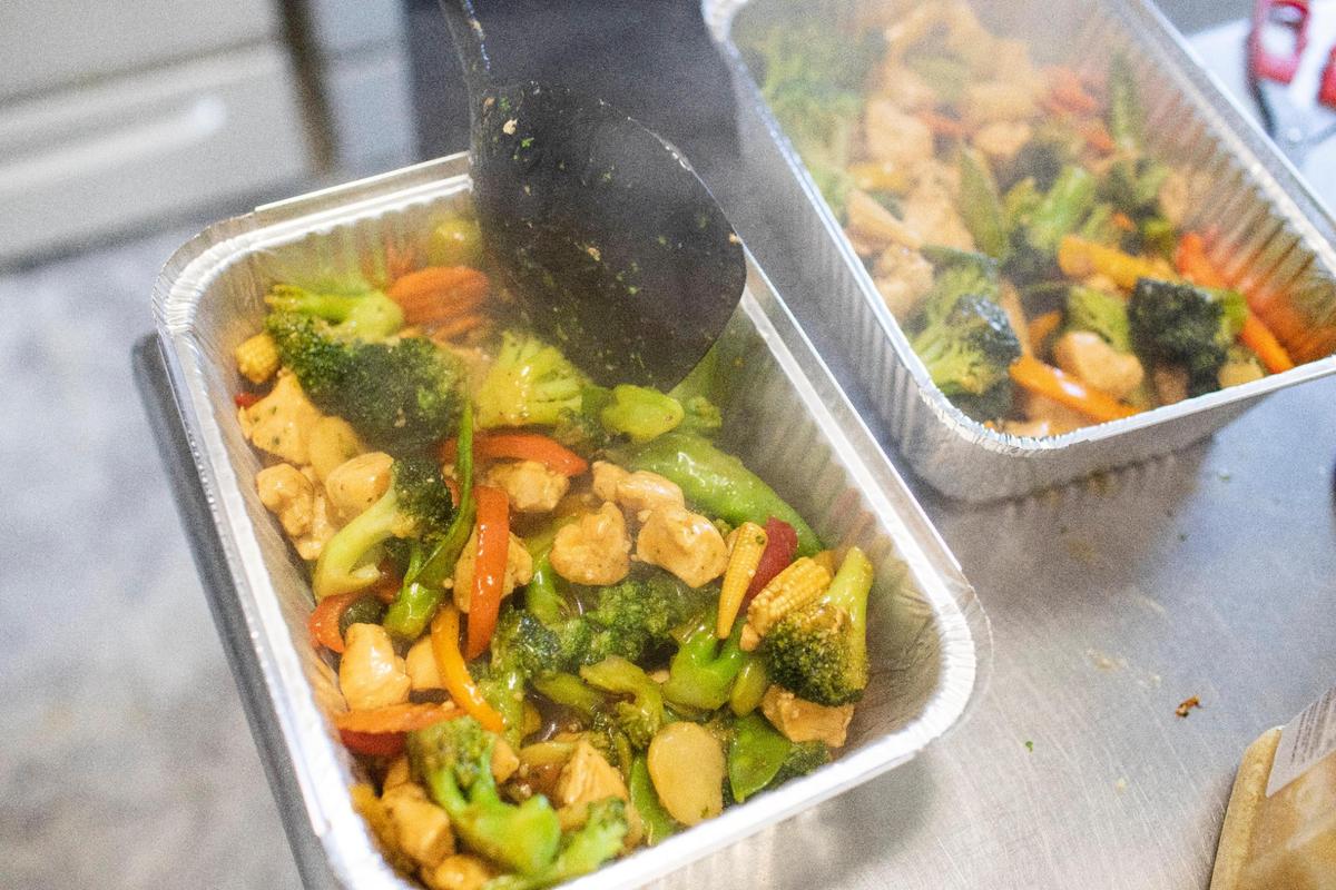 Bonnie Winfrey prepares one of her most popular dishes, stir-fry, at BebeÕs Kitchen in Jeffersonville, Ky., Tuesday, March 16, 2021.