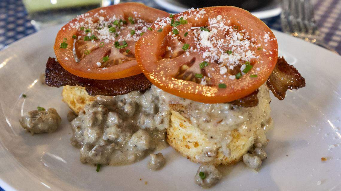 The breakfast hot brown ($16) at the Black Squirrel is made with homemade biscuits, sausage gravy, bacon, tomatoes and shaved Parmesan. Photographed Sunday, Feb. 1, 2026 at Black Squirrel in Versailles, Ky.