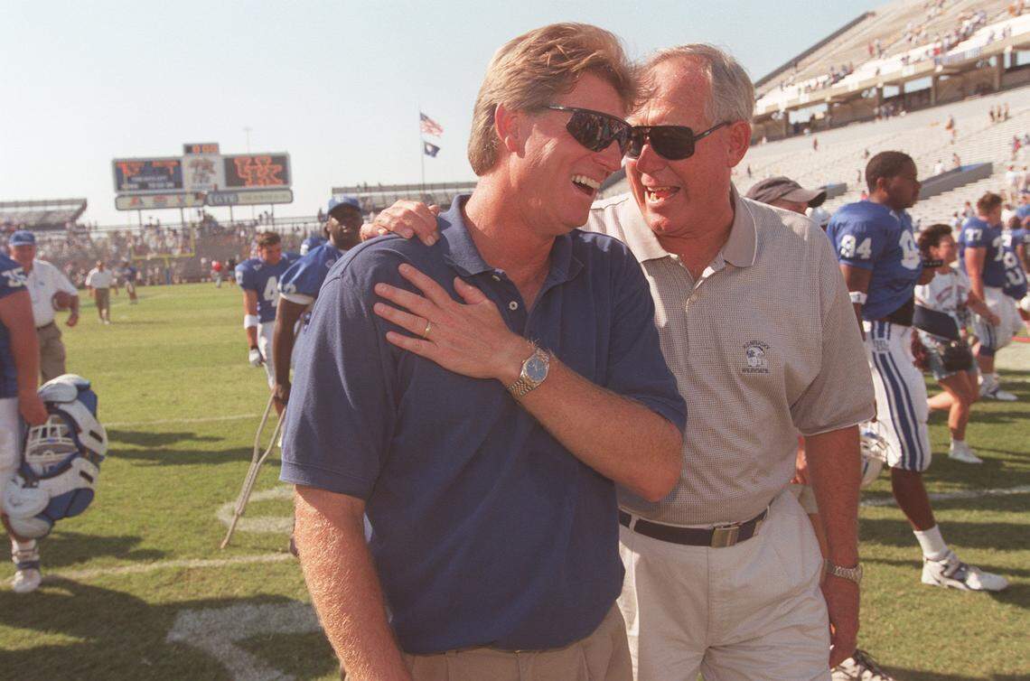 C.M. Newton congratulated head football coach Hal Mumme as they walked off the field after UK defeated EKU in Lexington in 1998.