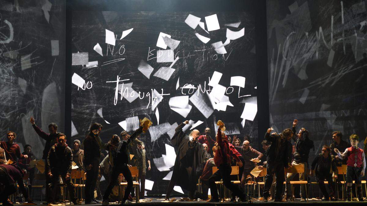 A tyrannical teacher (Dominic Lorange) punishes his riotous students in “Another Brick in the Wall.” CincinnatiOpera presents the U.S. premiere, July 20-31 at Cincinnati Music Hall.