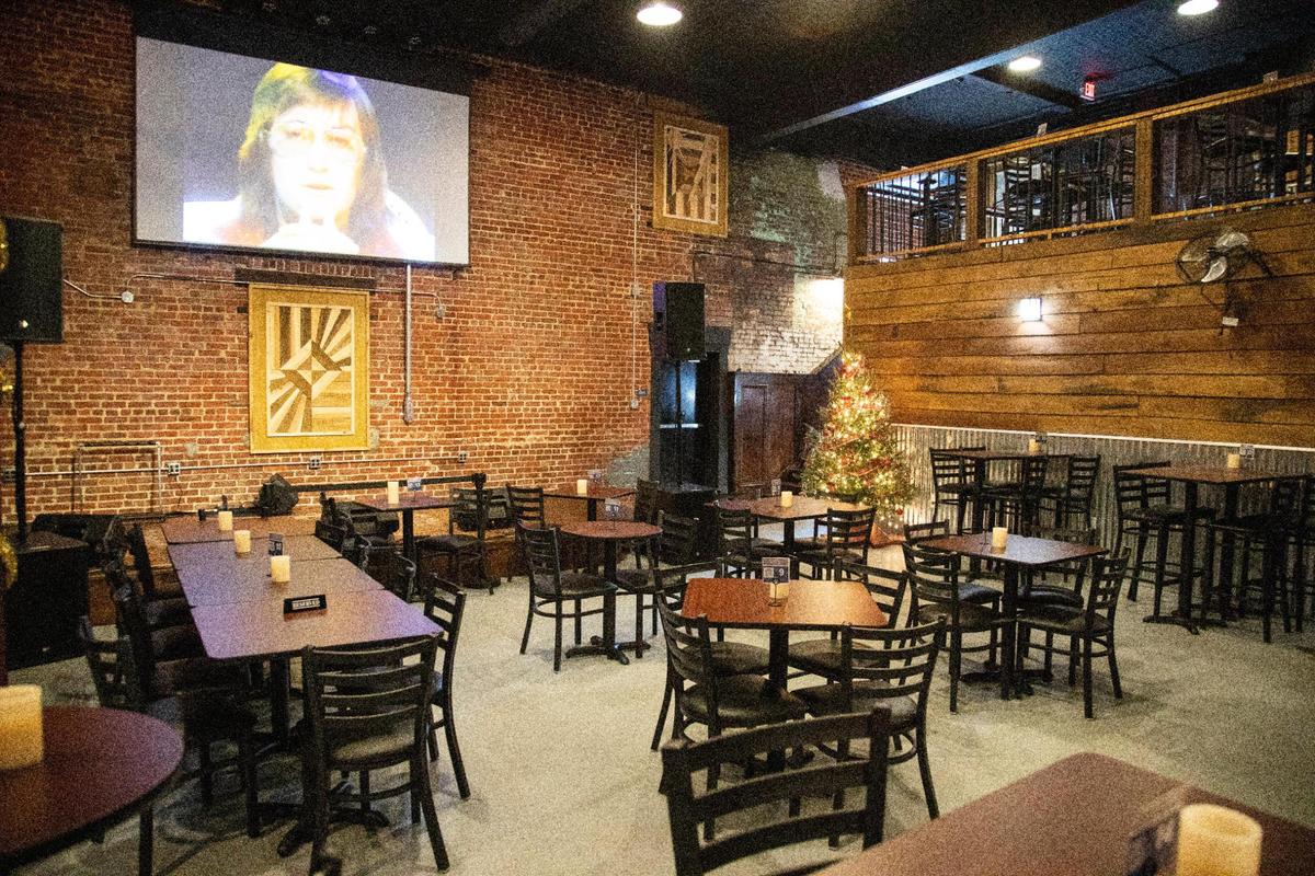 Part of the dining room and inside stage space at the Alley on Main in Paintsville, Ky., Wednesday, December 15, 2021. The venue has room for up to 300 people, features high ceilings, original brick walls, a second floor balcony and chandeliers for ambiance. They also serve food and drinks and plan to host a three-day music festival annually called the “Alley Fest.”