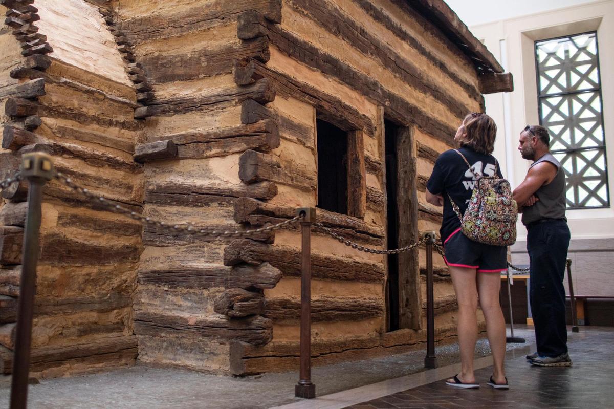 People look inside the a memorial to Abrahama Lincoln at a symbolic birthplace cabin in Hodgenville, Ky., Friday, July 9, 2021.