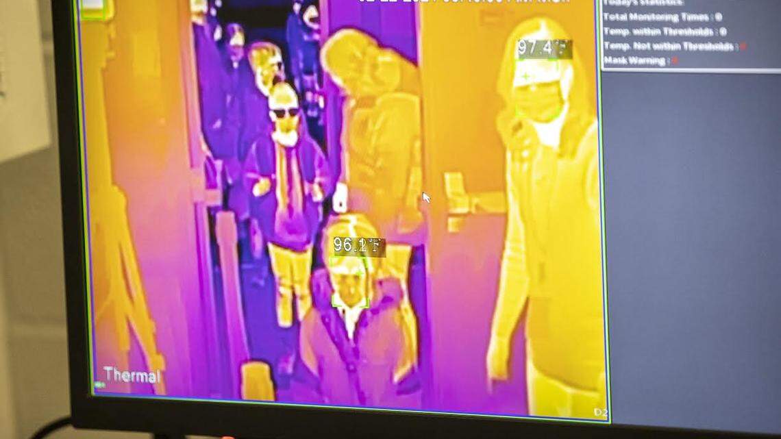 Students were let in one at a time so their temperatures can be checked at Veterans Park Elementary School in Lexington, Ky., on Monday, Feb. 22, 2021.