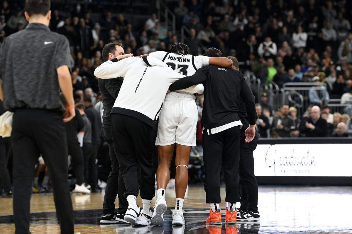 Providence forward Bryce Hopkins (23) is helped by staff after injuring a knee against Seton Hall on Wednesday night. On Thursday, the Friars announced Hopkins would miss the rest of this season.
