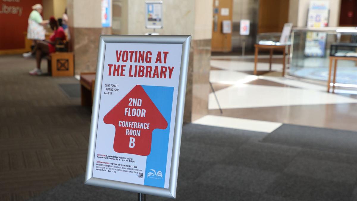 Voters are guided by library staff to the designated voting poll that’s located on the second floor of Lexington’s Central Public Library in downtown Lexington, Ky., May 21, 2024. The libraries will serve as voter centers and early voting locations in the Tuesday, Nov. 5 election.