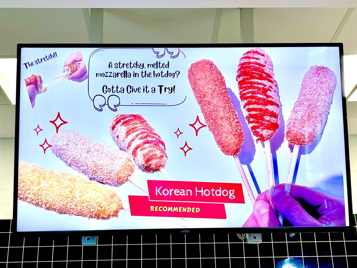 A menu board at Han Woo Ri on the University of Kentucky campus recommends you should Give it a Try when it comes to their Korean corn dogs.