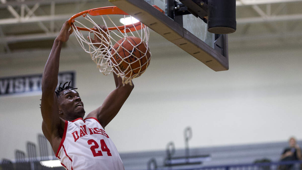 Daviess County’s DeAaron Watkins slammed in two of his 19 points against North Laurel in the semifinals of the White, Greer & Maggard Holiday Classic at Lexington Catholic High School on Monday.