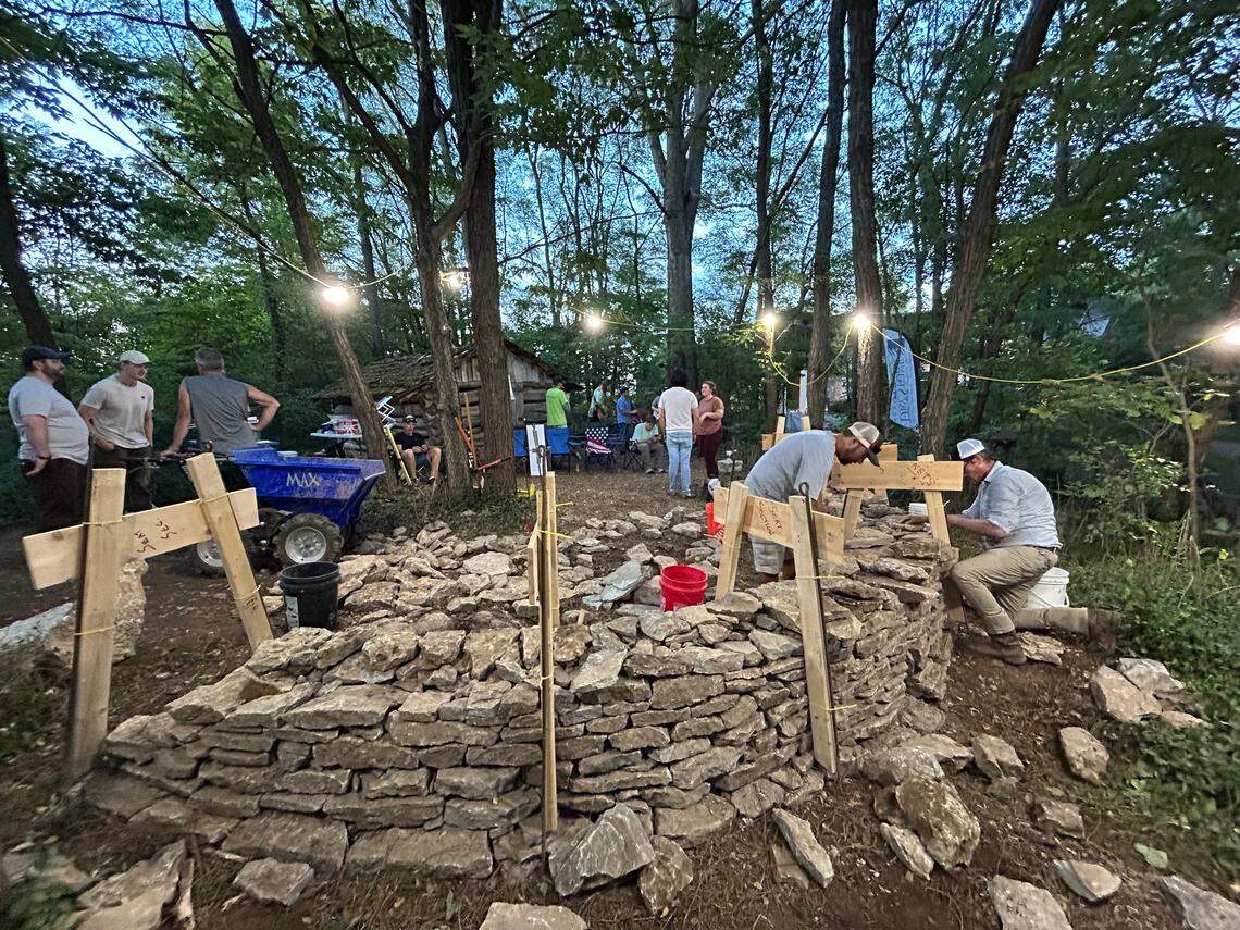 Masons and volunteers work on a dry stone wall at McConnell Springs as part of the Dry Stone Conservancy 24-hour walling marathon in September 2024, one of the nonprofit’s most popular events.