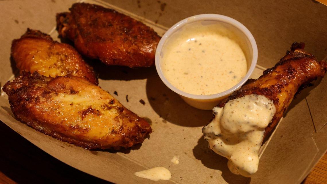 An order of smoked chicken wings with Alabama white sauce from Double H BBQ. The white sauce is homemade the most popular for the wings.
