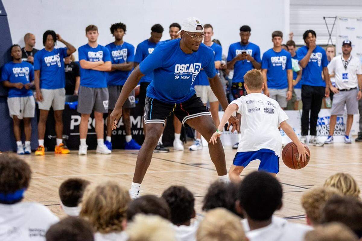 Former Kentucky basketball star Oscar Tshiebwe plays one-on-one with a camper at his youth basketball camp at Sports Center in Lexington on Sunday.