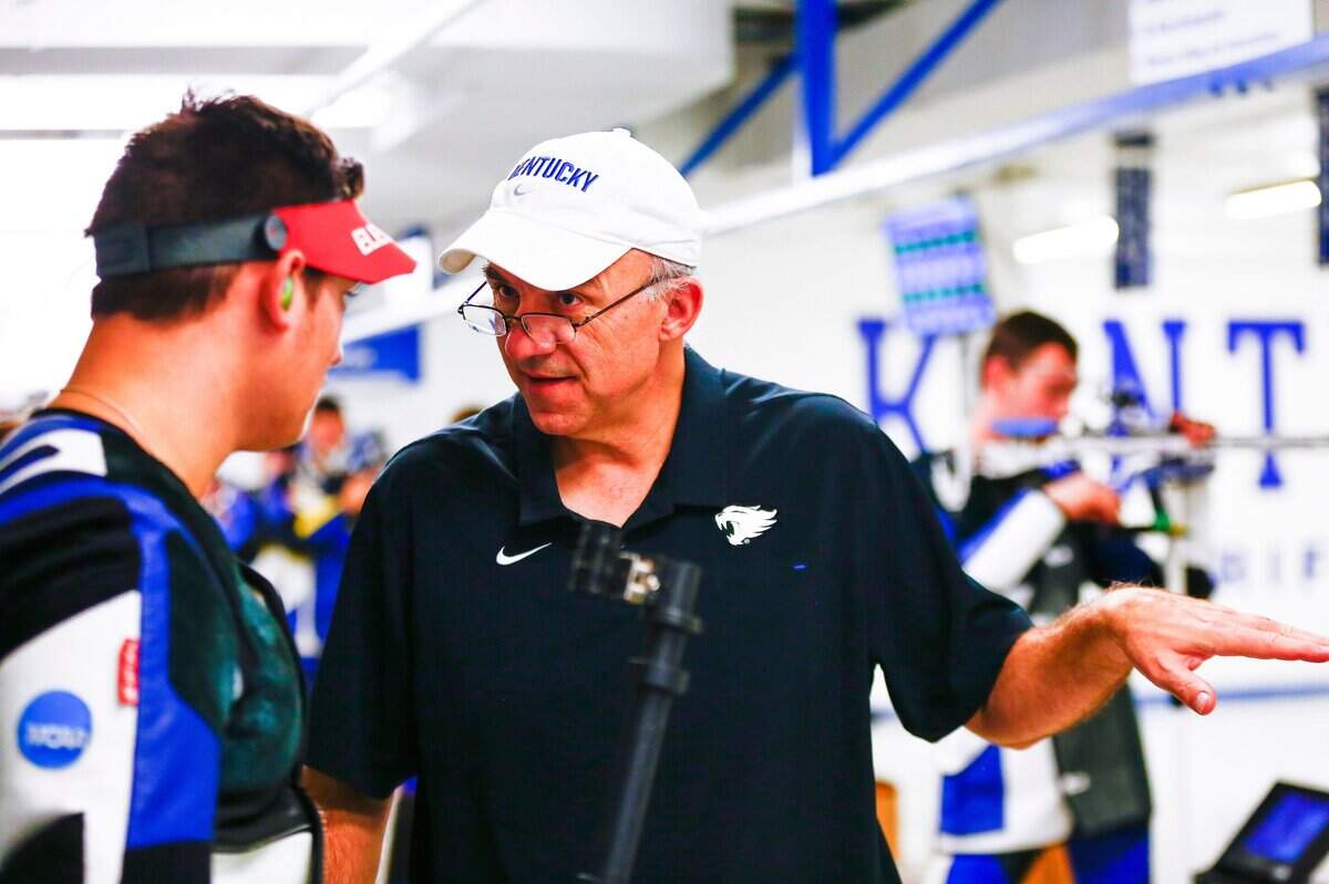 Kentucky rifle coach Harry Mullins, right, has led the Wildcats to four NCAA team championships.