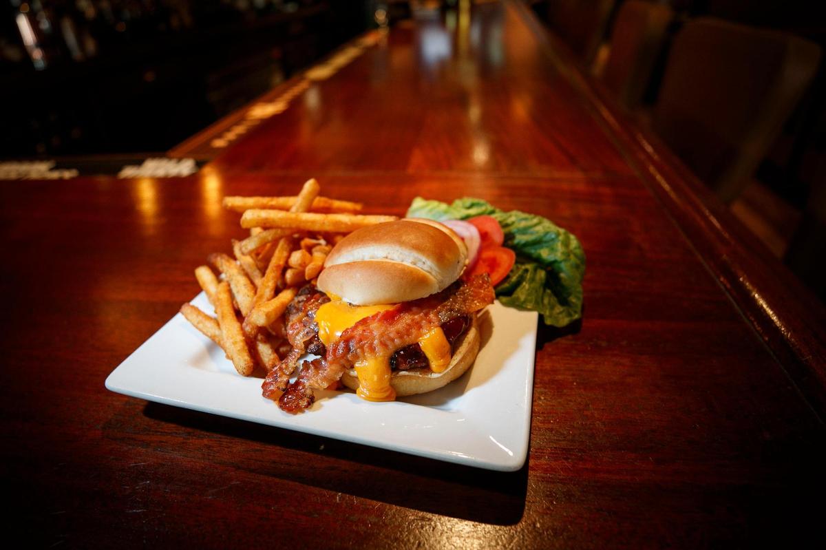 The Three B’s Burger made with a 6oz charbroiled steak burger on a toasted bun topped with bacon, barbecue sauce and beer cheese and served with fries at The Goose of Lexington in Lexington, Ky., Wednesday, May 5, 2021.