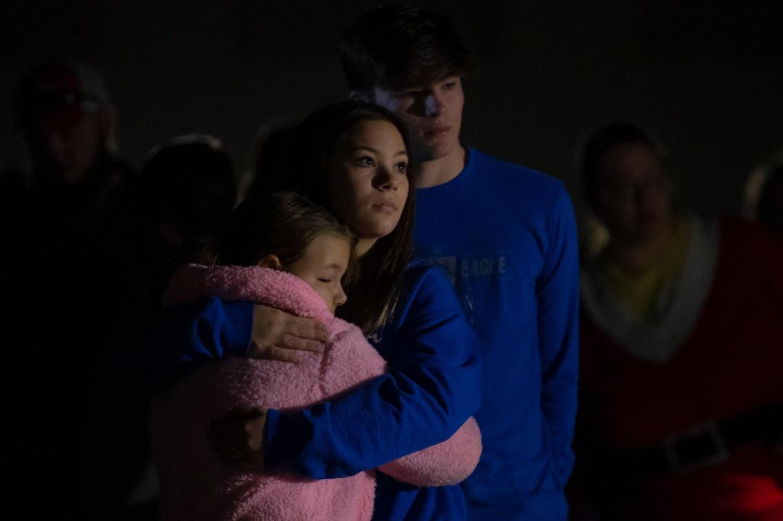 Raylin Richards, 8, from left, Mckenzie Page, 14, and Landon Curd, 15, attend a worship service at His House Ministries in Mayfield, Ky., on Sunday, Dec. 12, 2021.