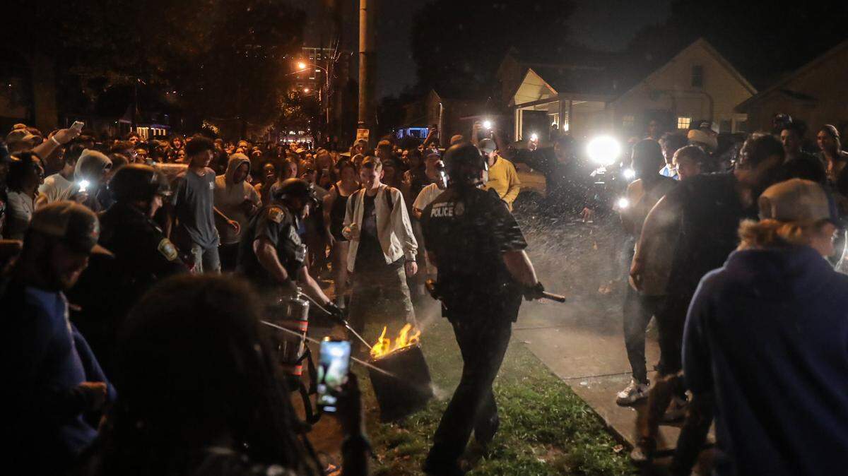 Lexington Police extinguish a small fire on State Street on Oct. 10, 2021. Police arrested one person for disorderly conduct after UK’s win over LSU.